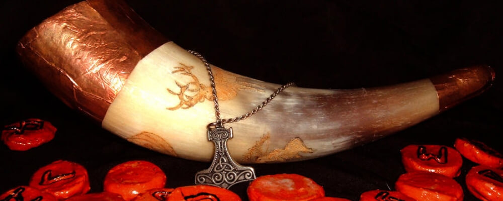 asatru beliefs symbols thor hammer and runes with a drinking horn
