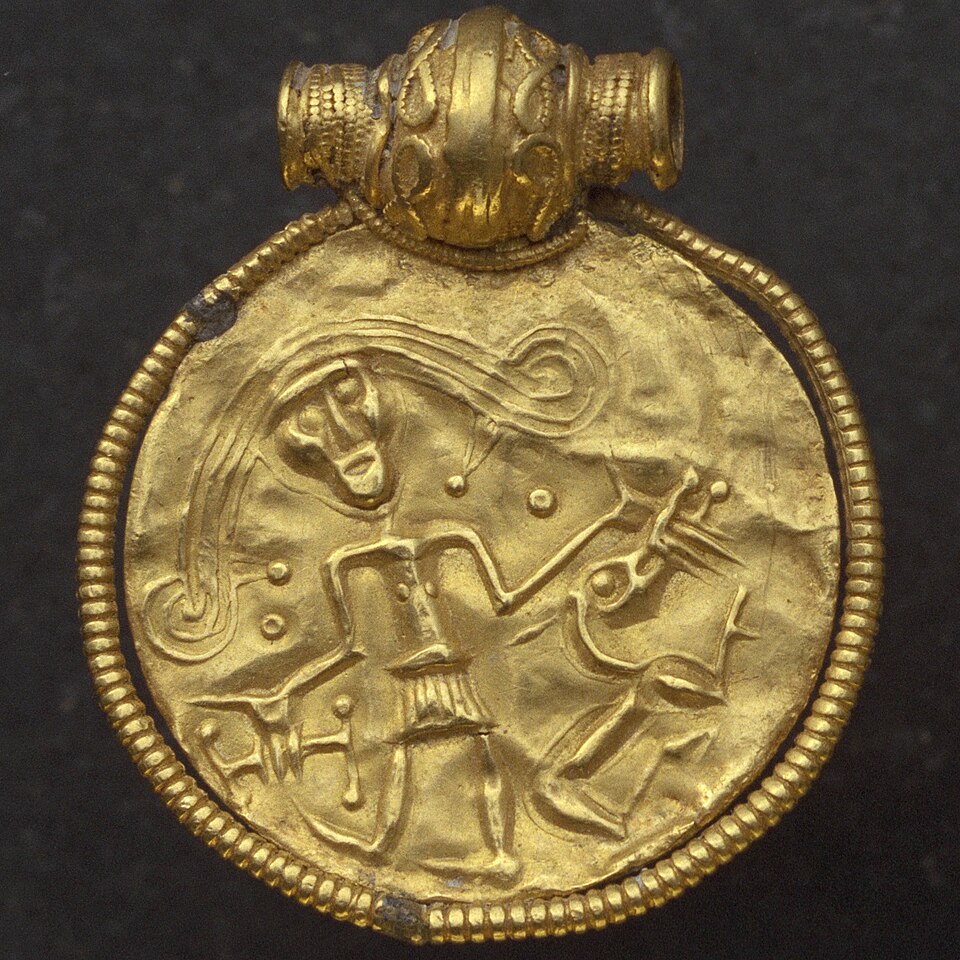 Trollhättan bracteate showing man with hand in the mouth of a wolf, probably Tyr and Fenrir, c. 700