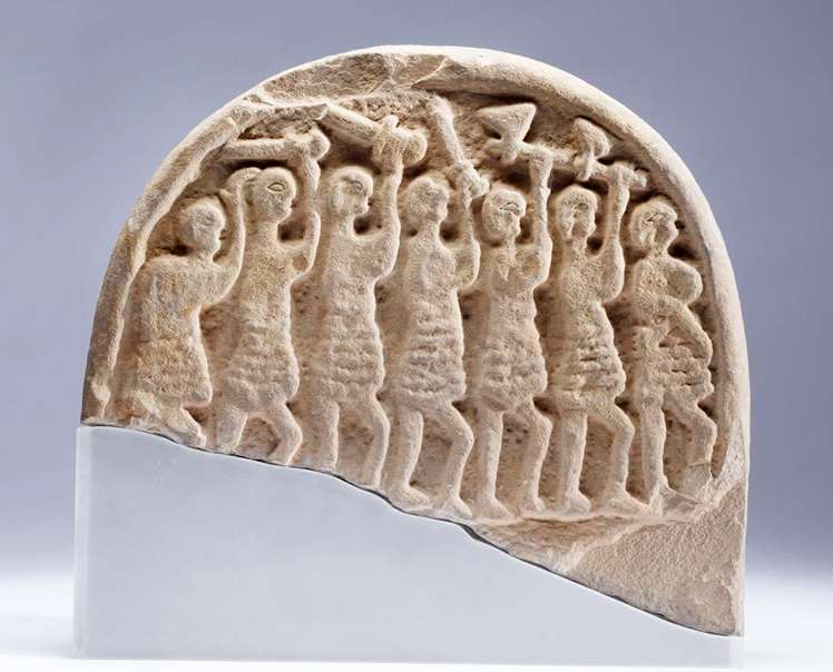 Gravestone marker from Lindisfarne showing men attacking with Viking-style swords, c. 900